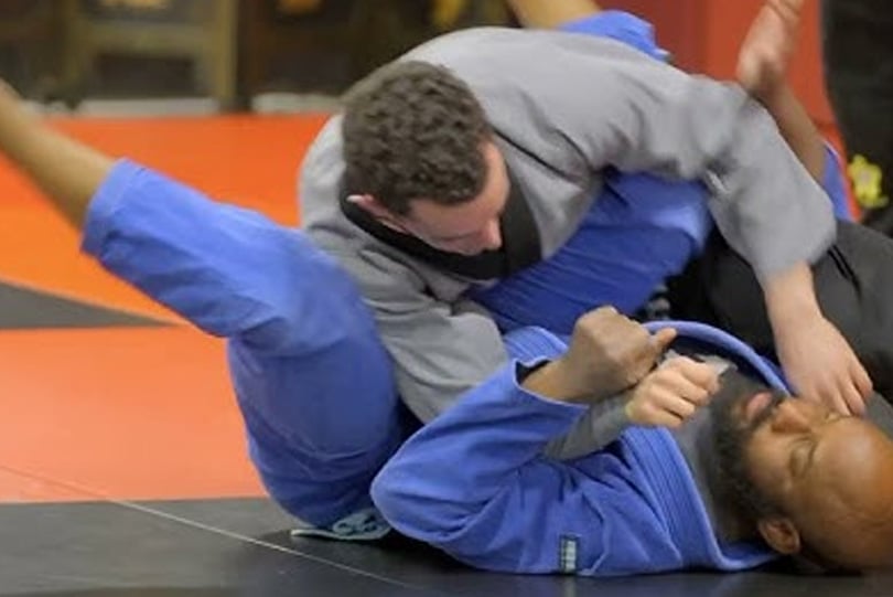 Two Ghost Team BJJ students grappling in gis on the mats at MPower Gym & Academy